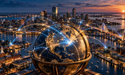 Antique globe over Boston Harbor at sunset with blue and gold connections across the city