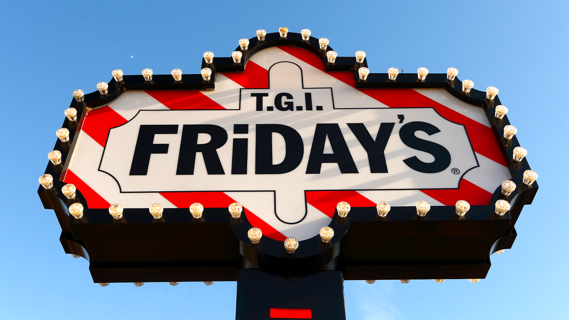 Classic TGI Fridays marquee sign with red-and-white stripes