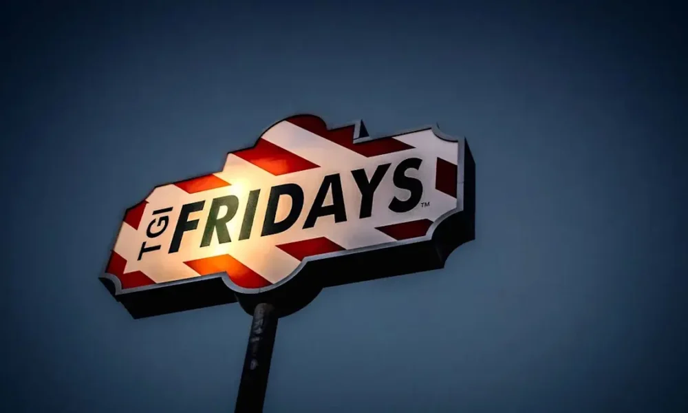 TGI Fridays sign lit against a darkening evening sky