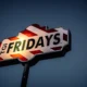 TGI Fridays sign lit against a darkening evening sky