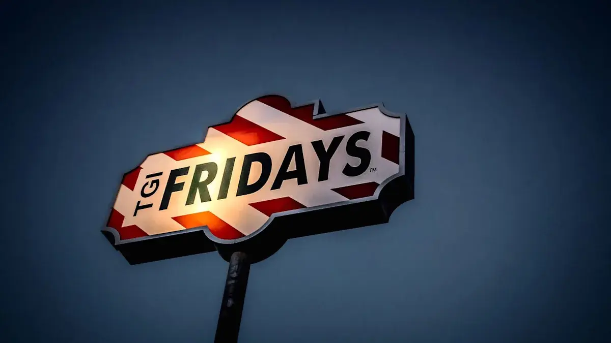 TGI Fridays sign lit against a darkening evening sky