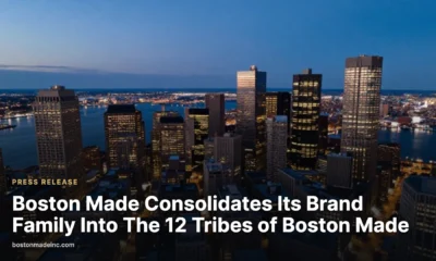 Downtown Boston at blue hour seen from above with lit buildings and the harbor.
