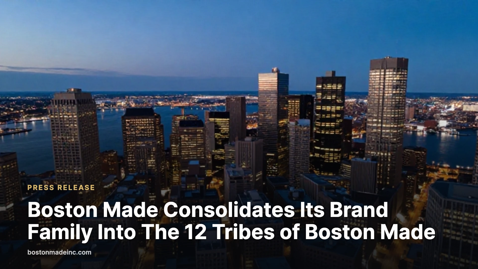Downtown Boston at blue hour seen from above with lit buildings and the harbor.
