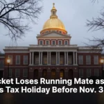 The Massachusetts State House dome at dusk with wet brick sidewalks in the foreground.