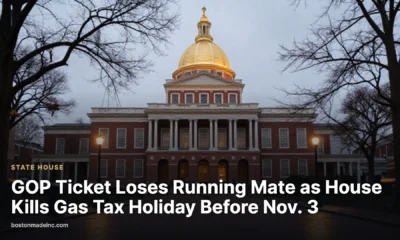 The Massachusetts State House dome at dusk with wet brick sidewalks in the foreground.